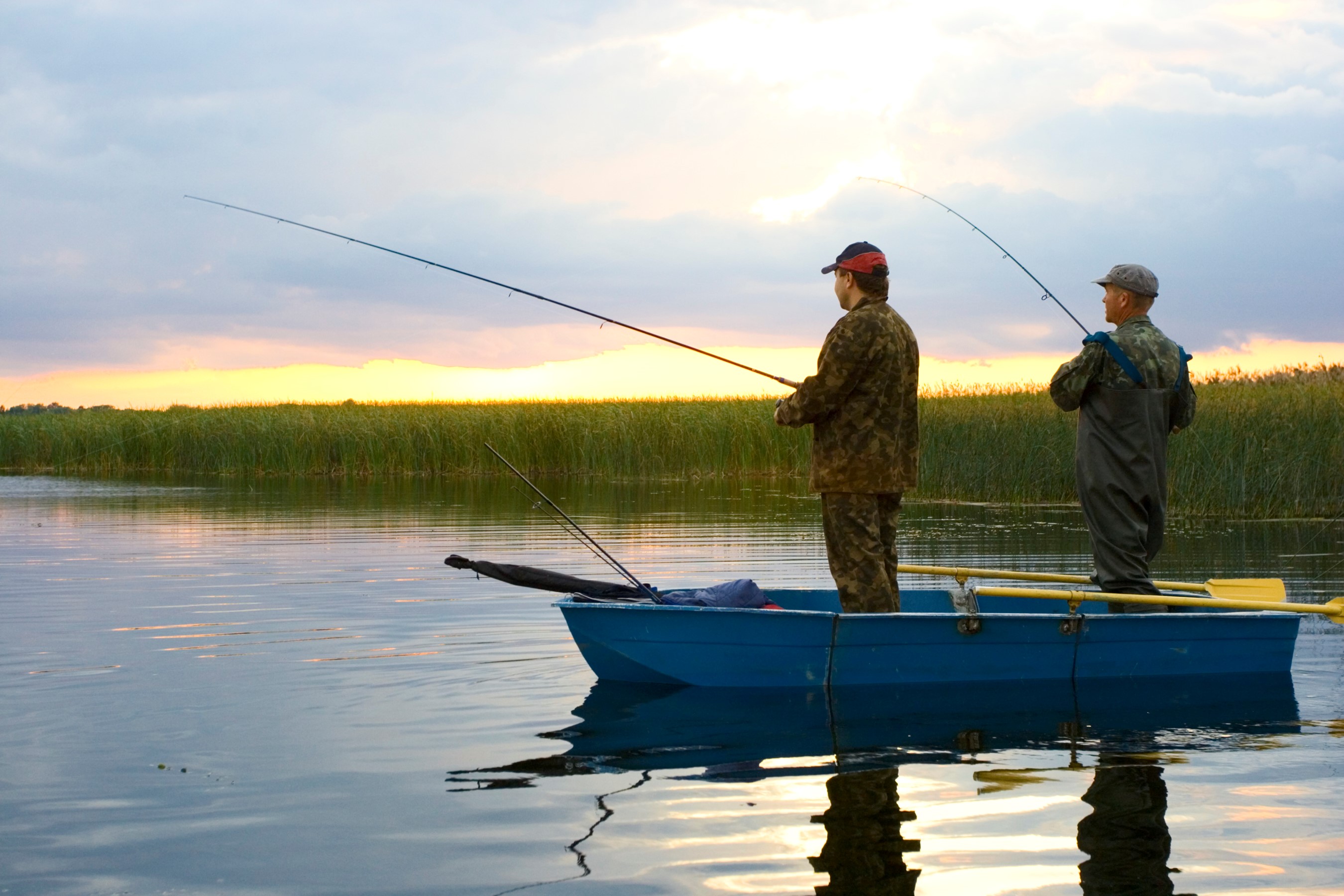 Fishermen casting lines at dusk. Eating fish is one of the most common ways we're exposed to mercury.