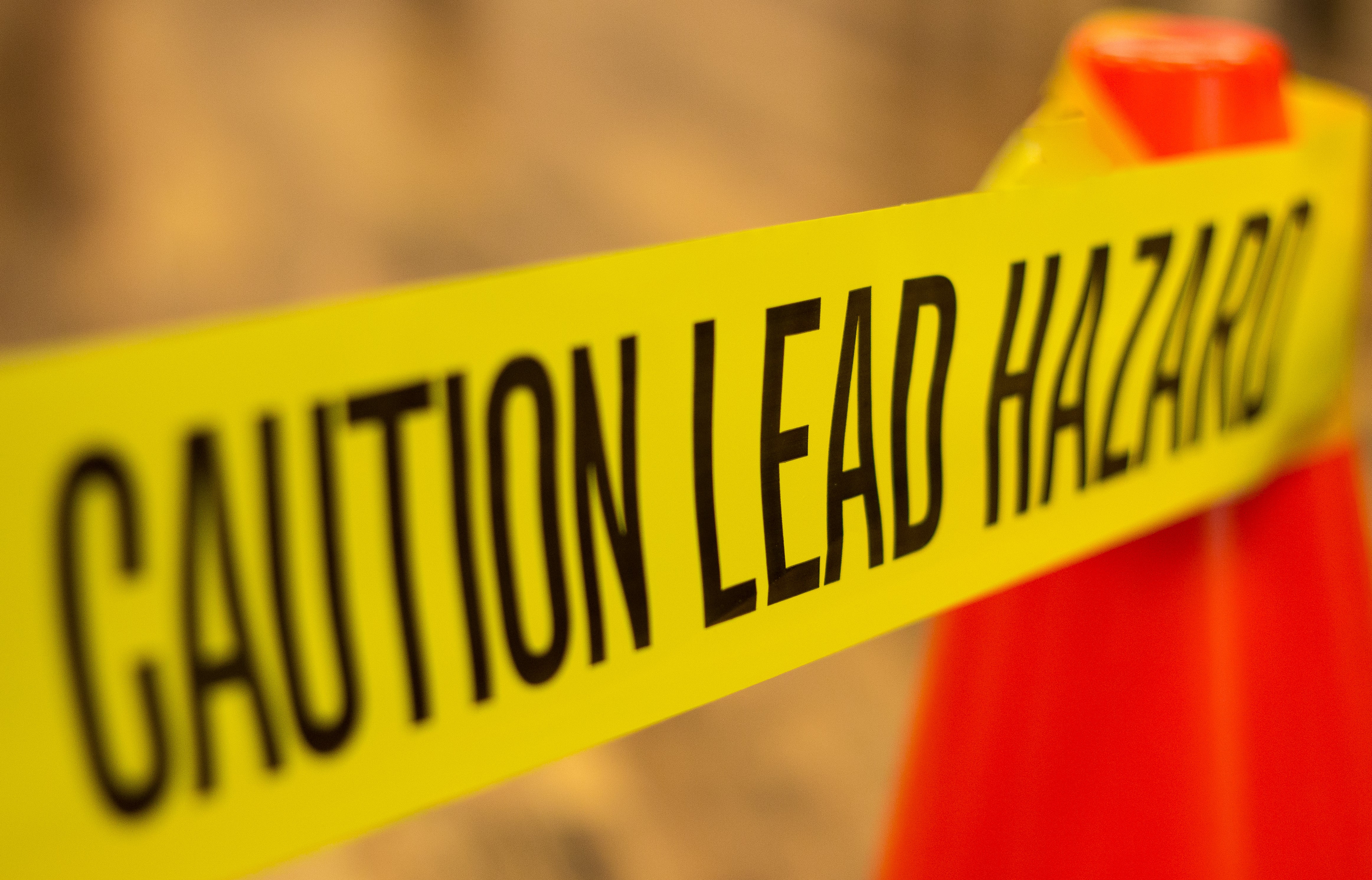 Caution tape describing lead-based paint hazard.