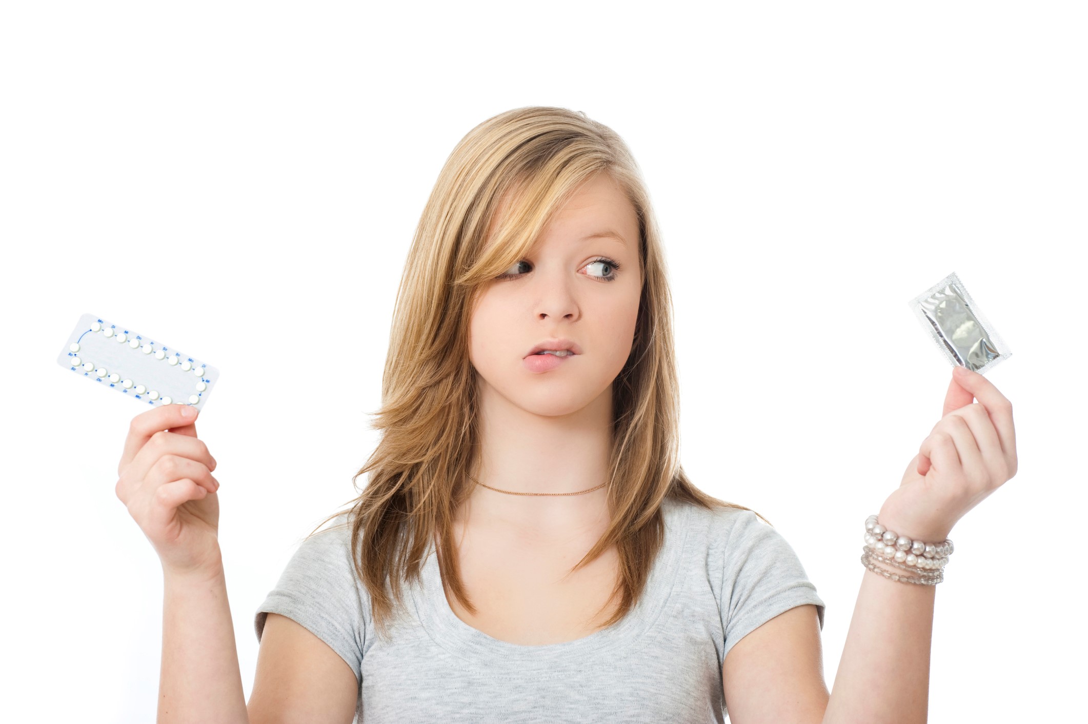 Young woman choosing between birth control methods.