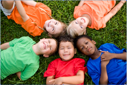 children laying in the grass